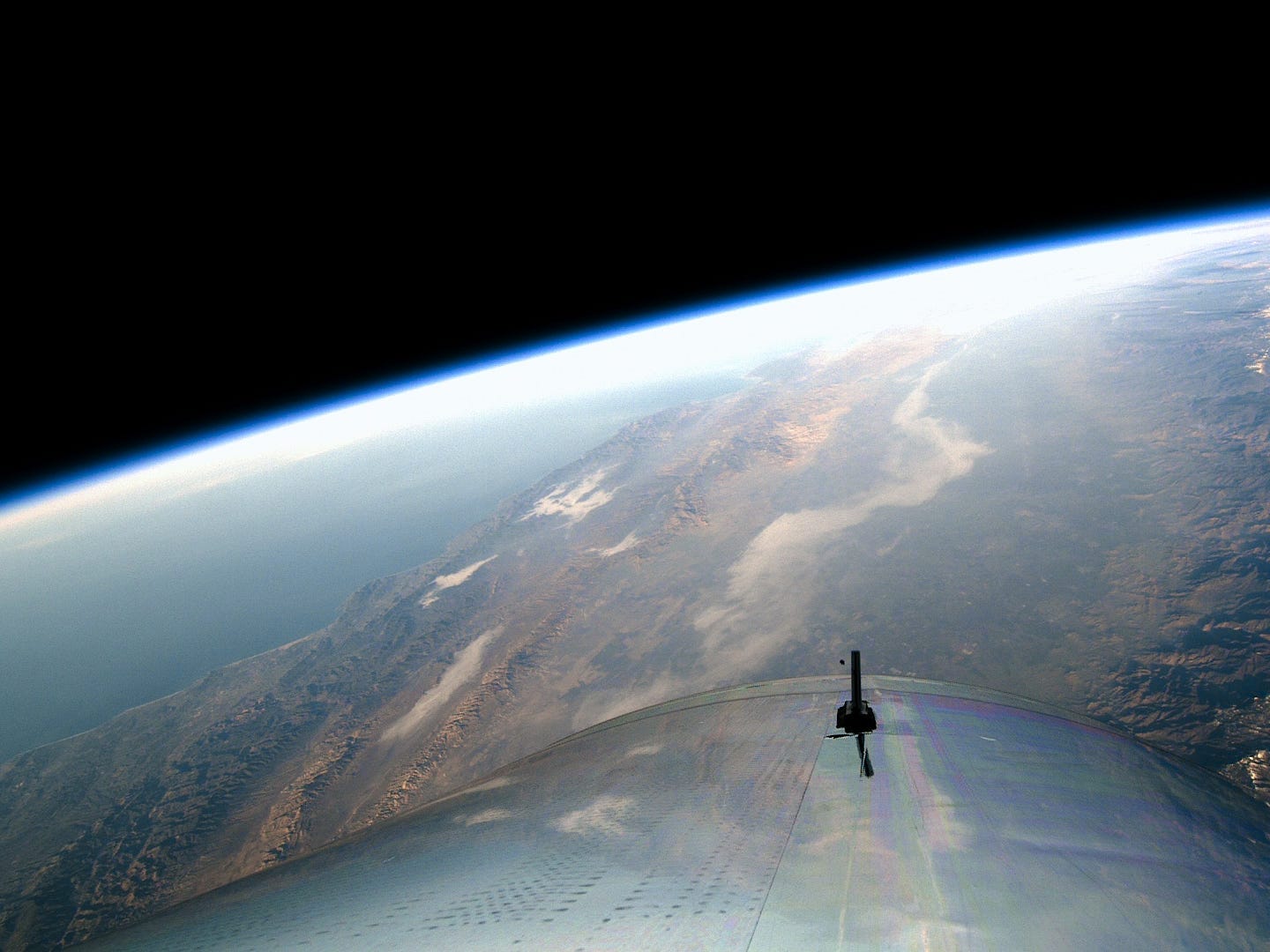 A Virgin Galactic spacecraft above the earth