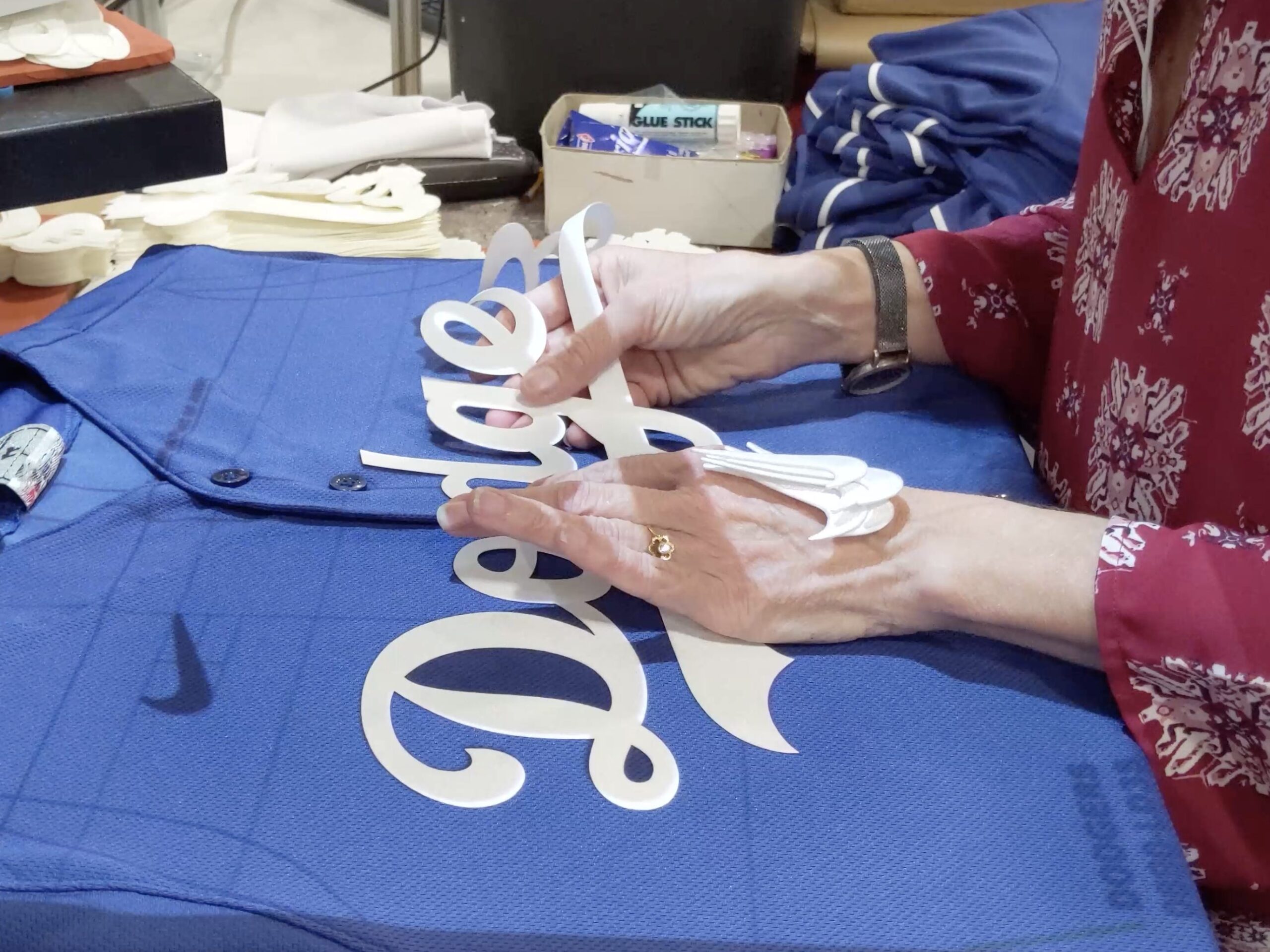 Production workers at a Fanatics’ contract supplier facility in Vietnam, putting a logo on a shirt