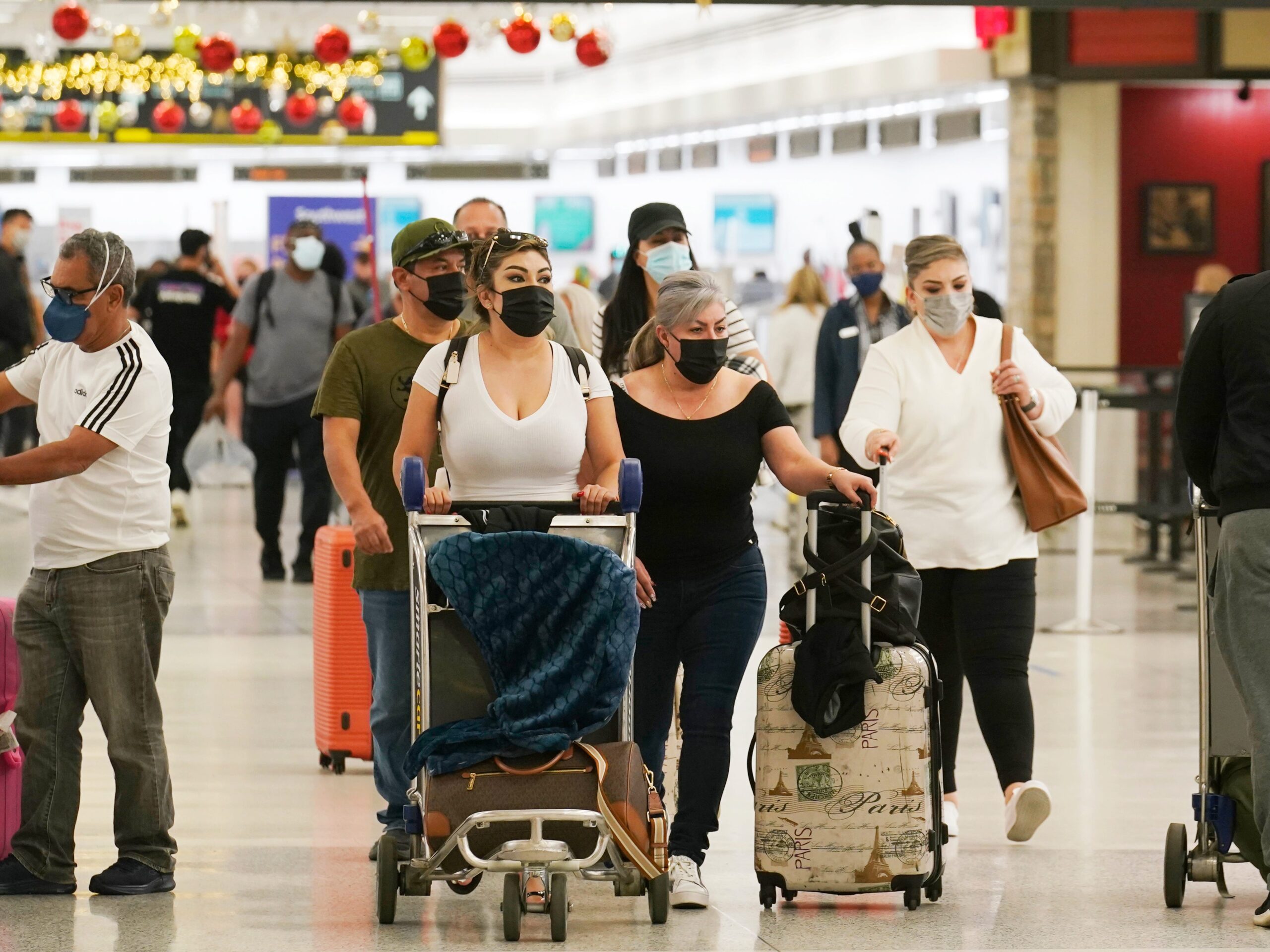 Travelers walk through the airport.