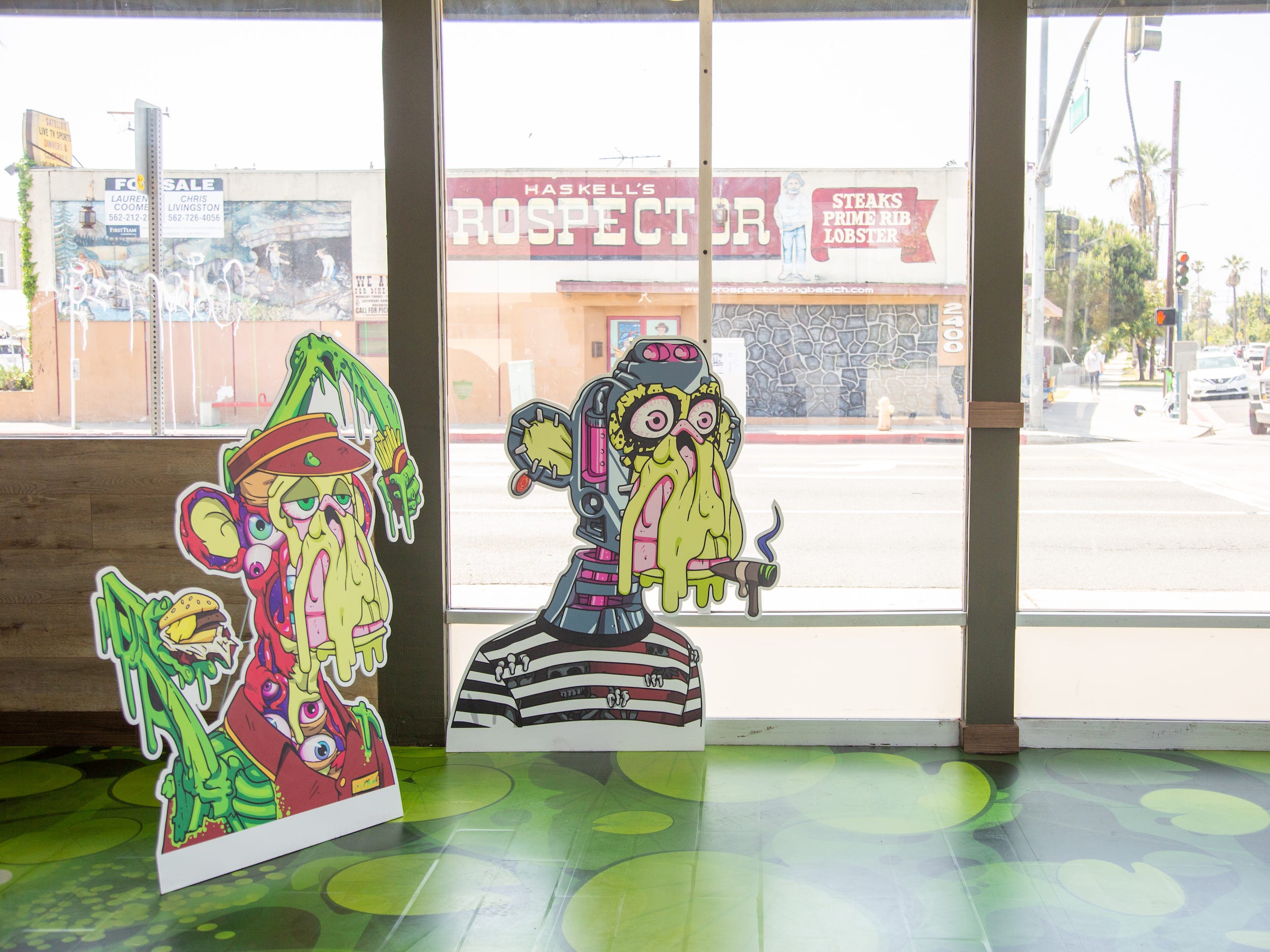 Inside the Bored and Hungry store with ape cutouts.