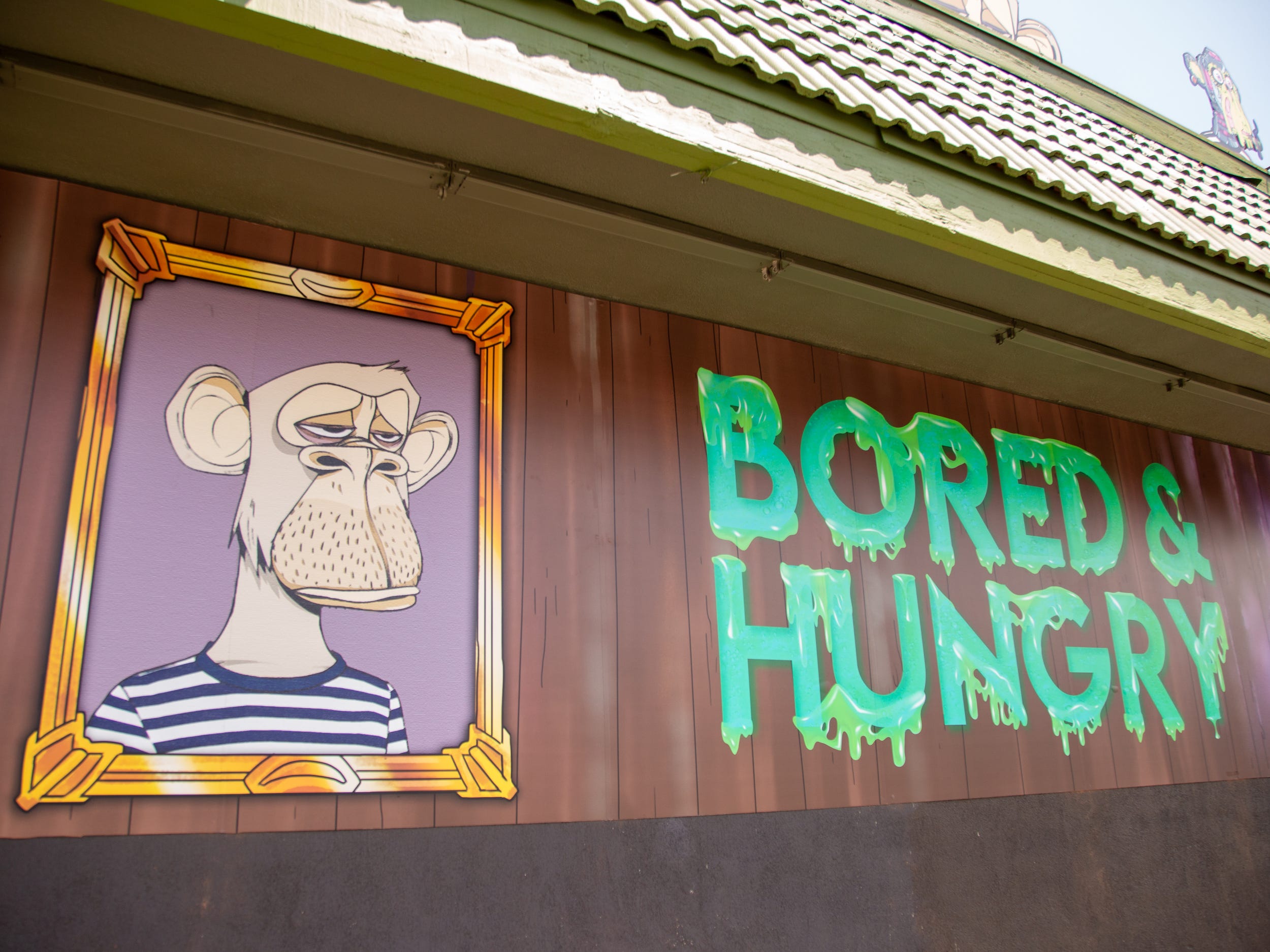 Outside the Bored and Hungry store with ape decal and the store name.