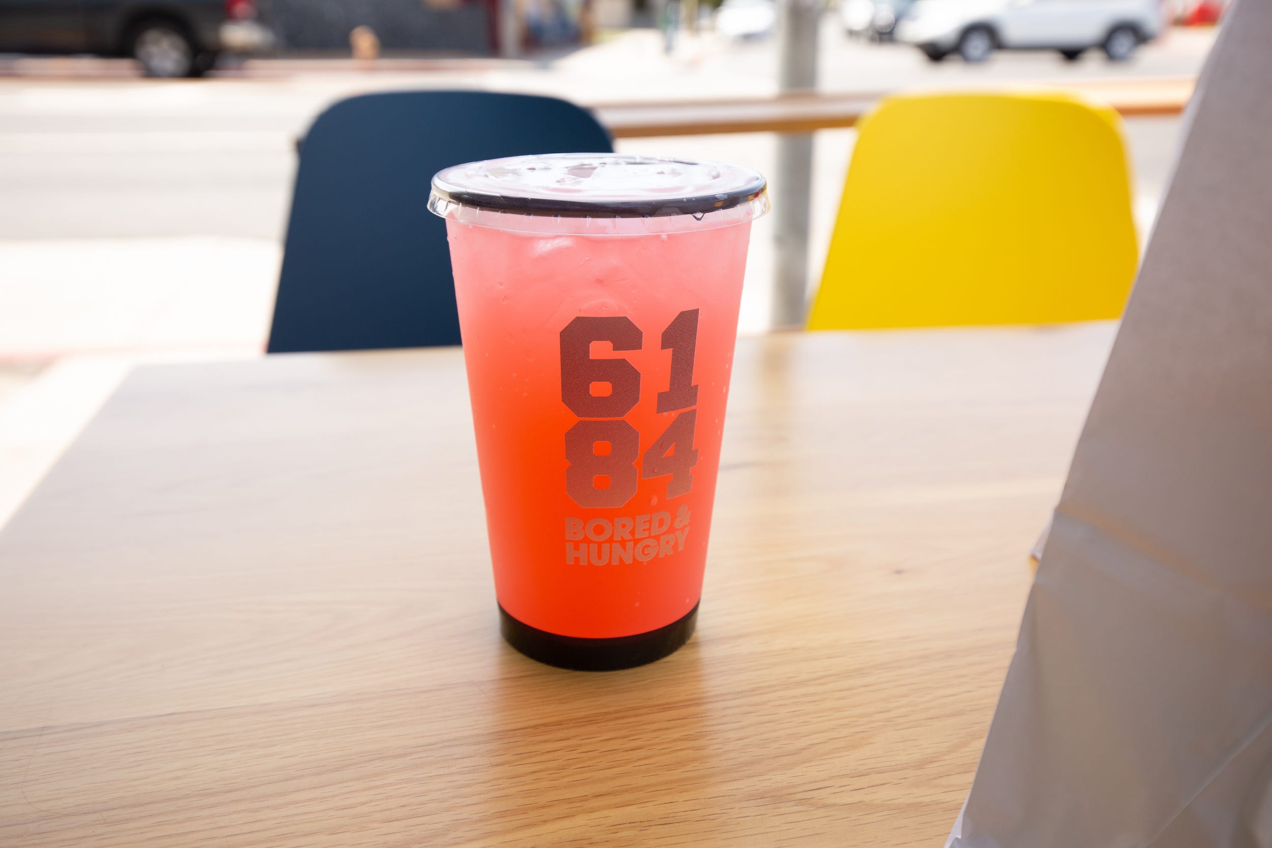 A pink beverage inside a plastic cup.