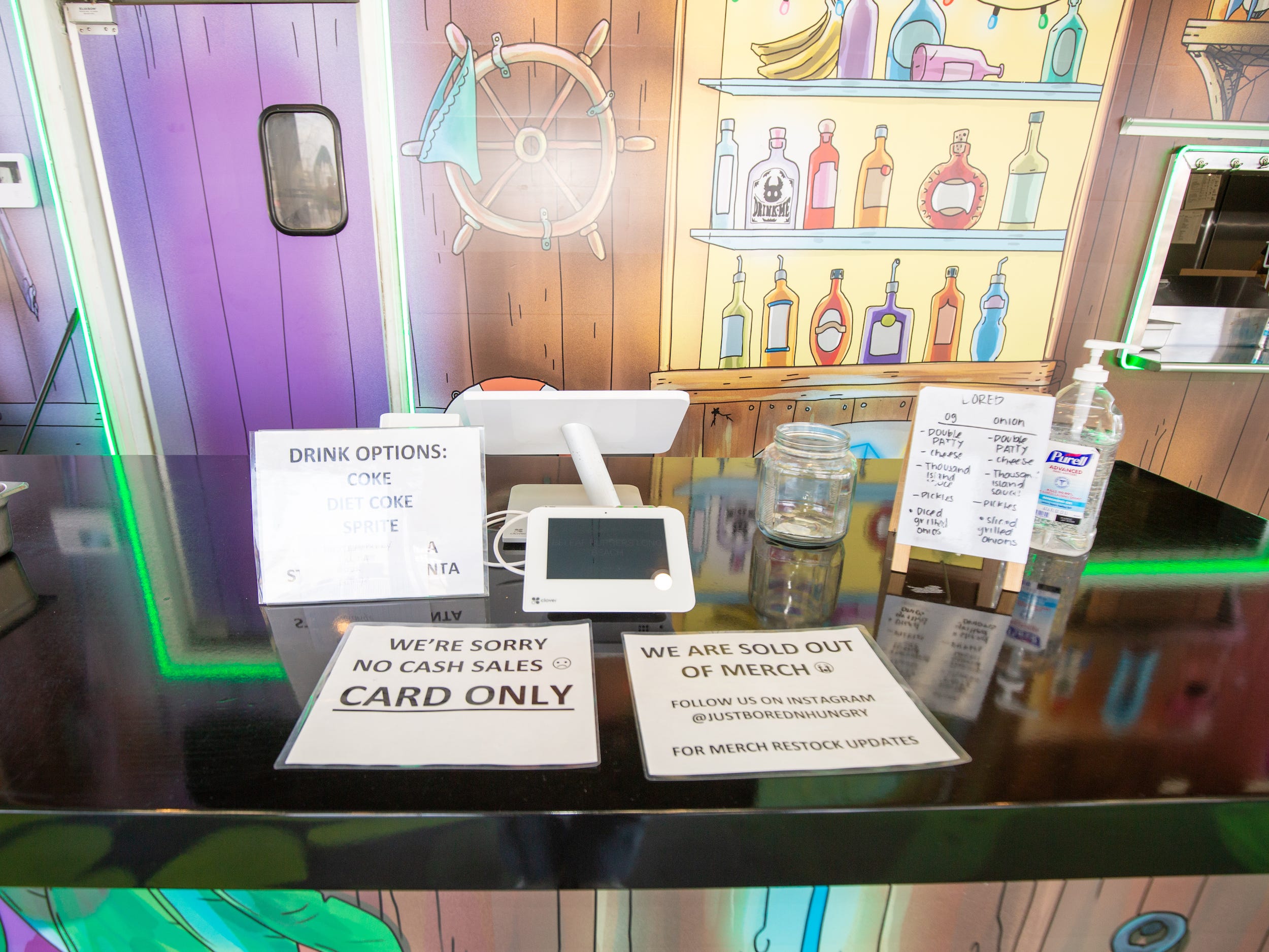 The cash register at the Bored and Hungry store with wall decals.