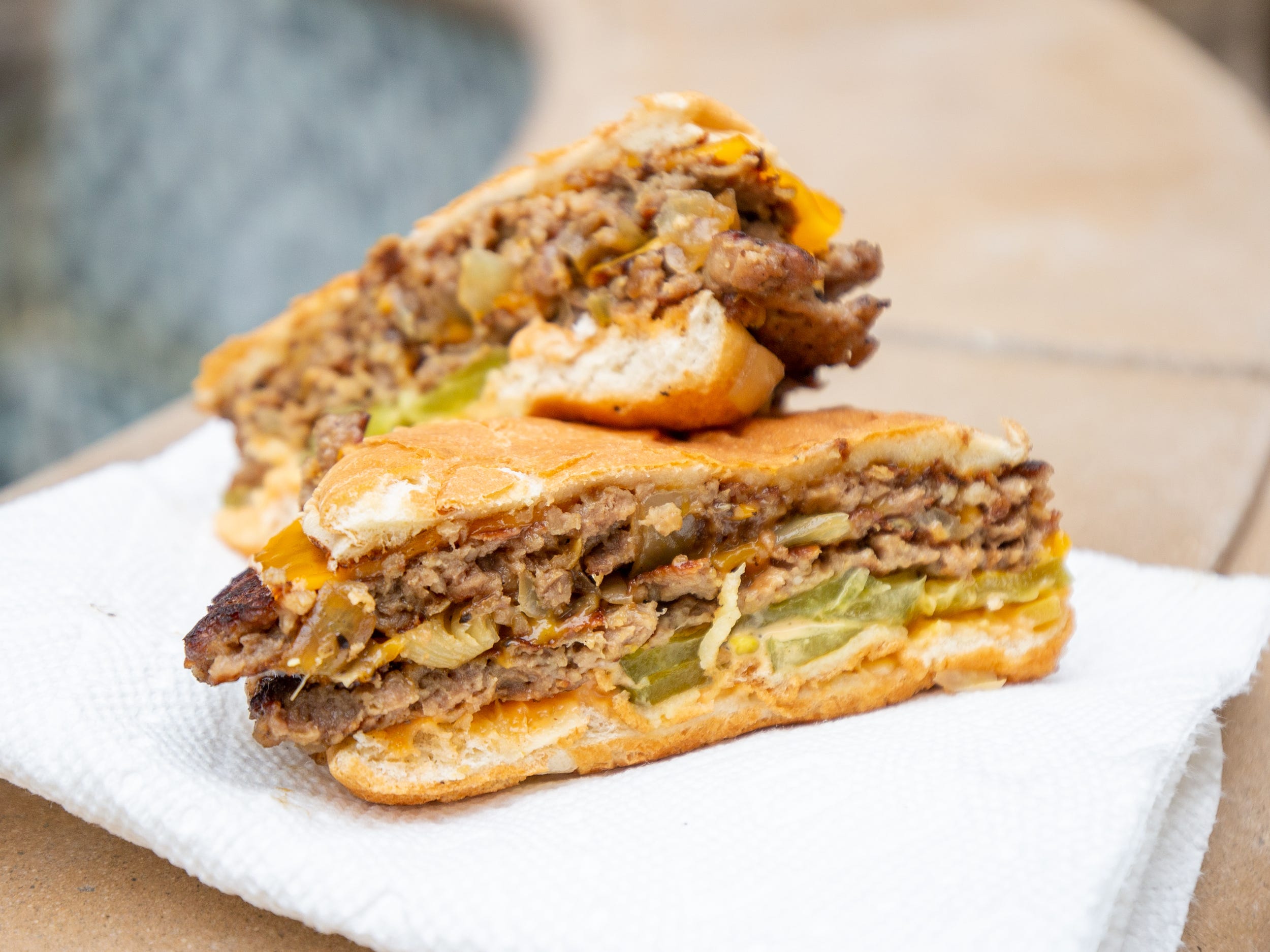 A cross section of the vegan burger on a white napkin.