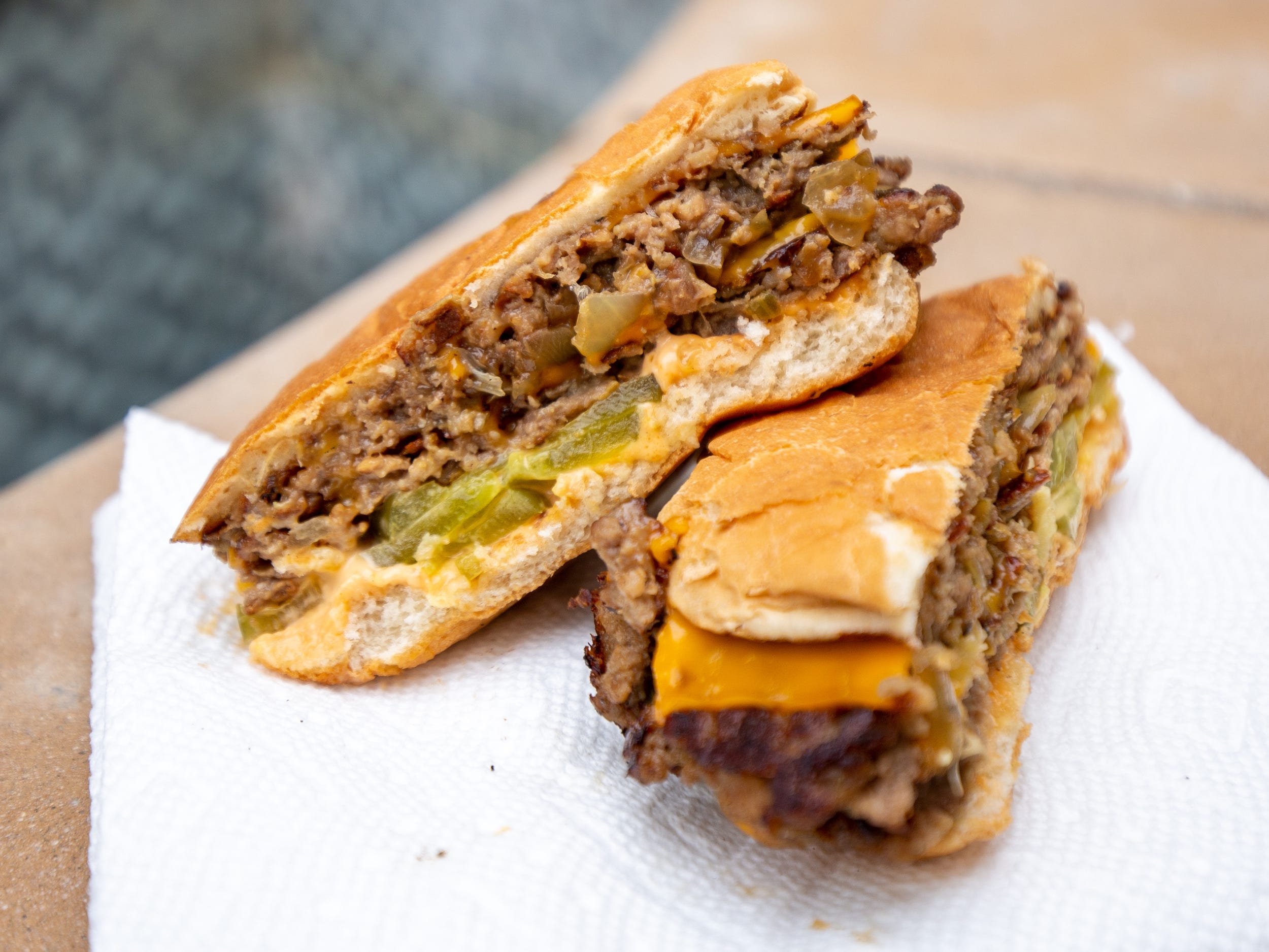 A cross section of the vegan burger on a white napkin.