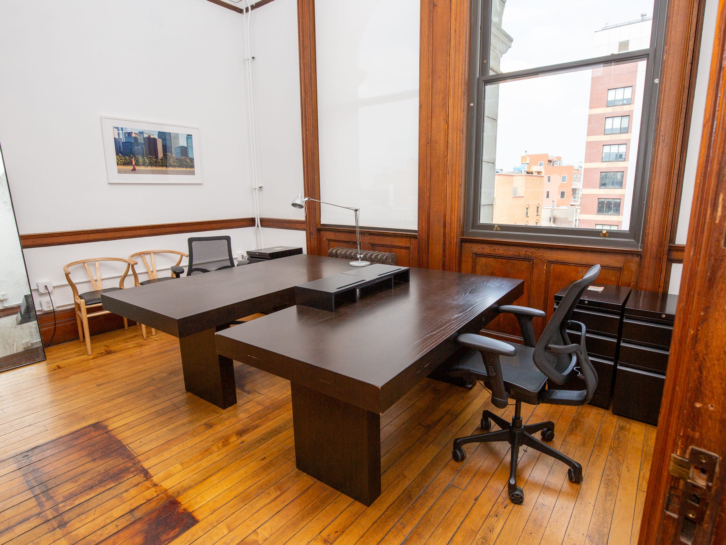 Table, chairs, and large windows.