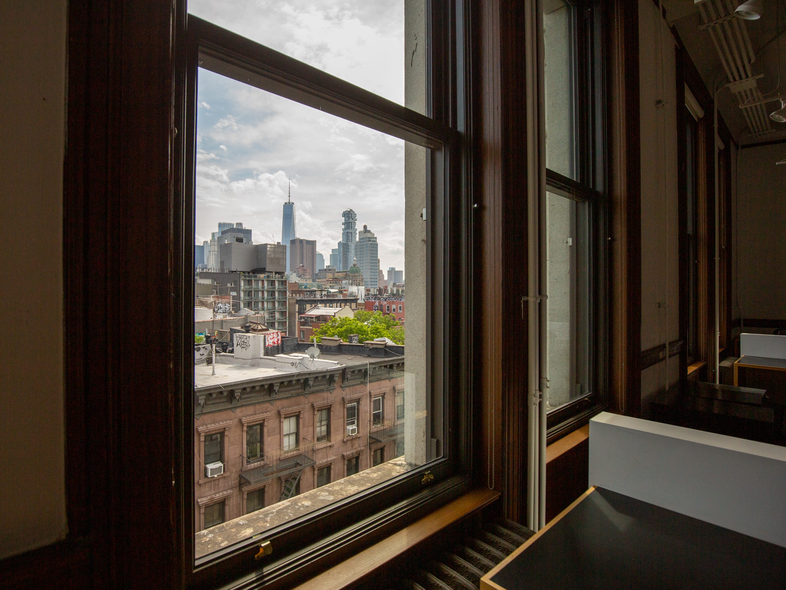 The view of the NYC skyline from a window.