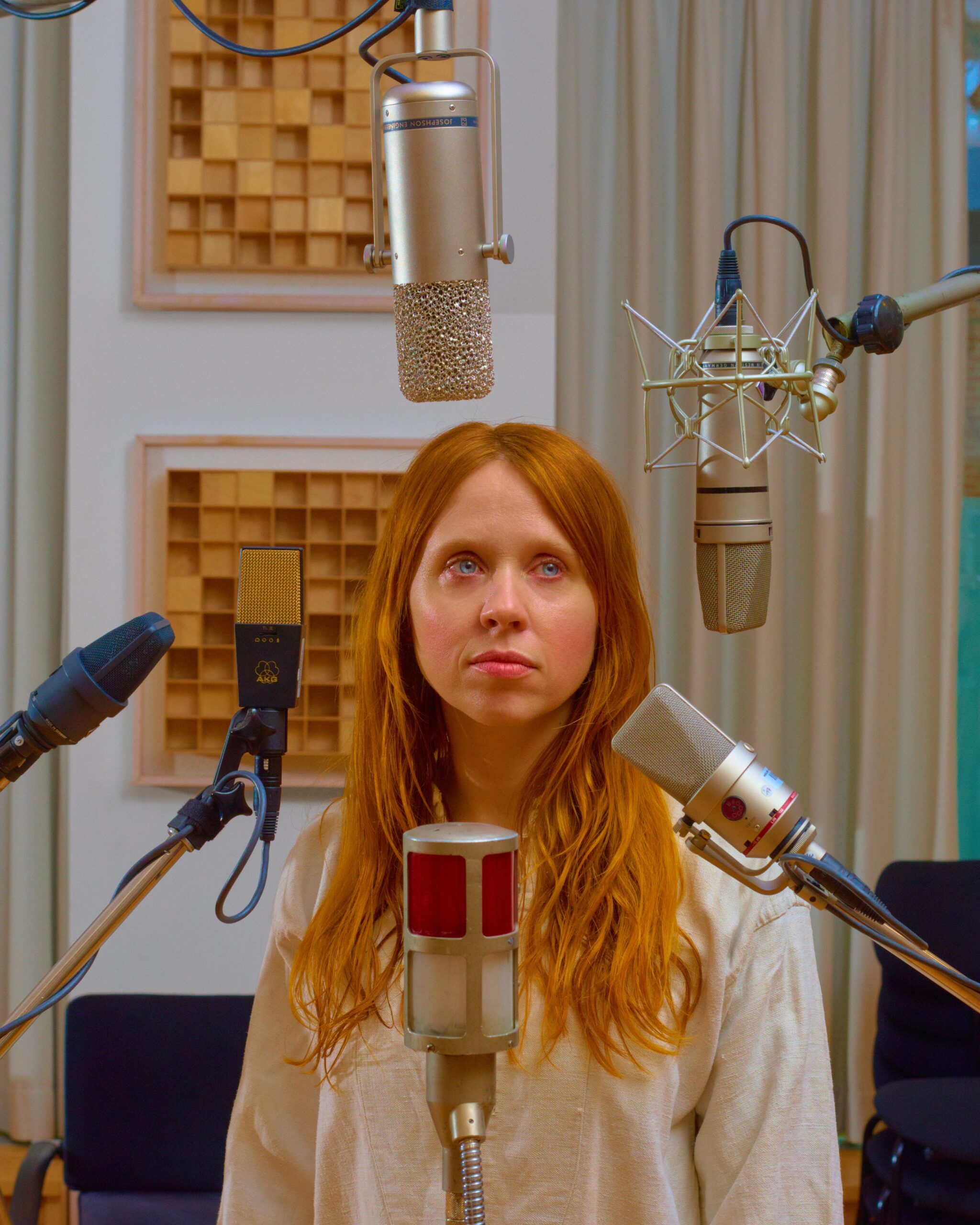 Holly Herndon surrounded by mics.