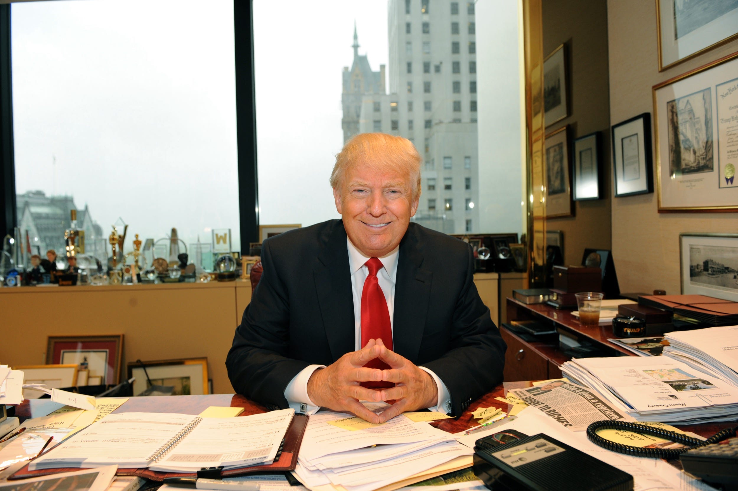 donald trump tower sitting desk smiling smile