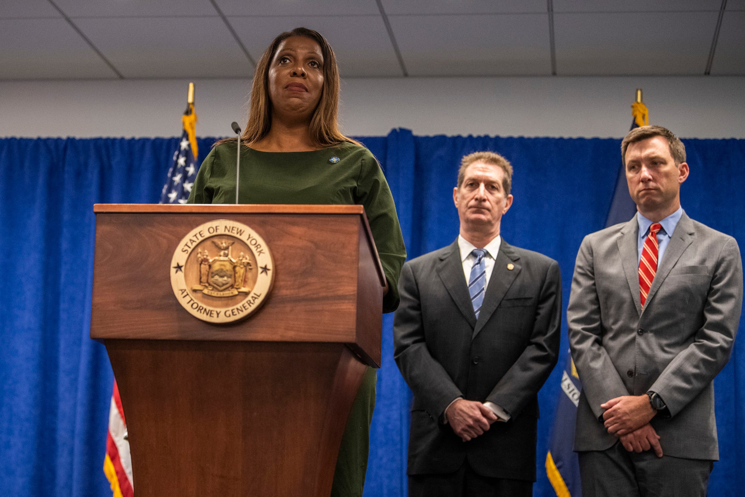 New York Attorney General Letitia James announced her $250 million civil fraud suit against Donald Trump and his company with assistant attorneys general Andrew S. Amer, center, and Kevin C. Wallace, right.