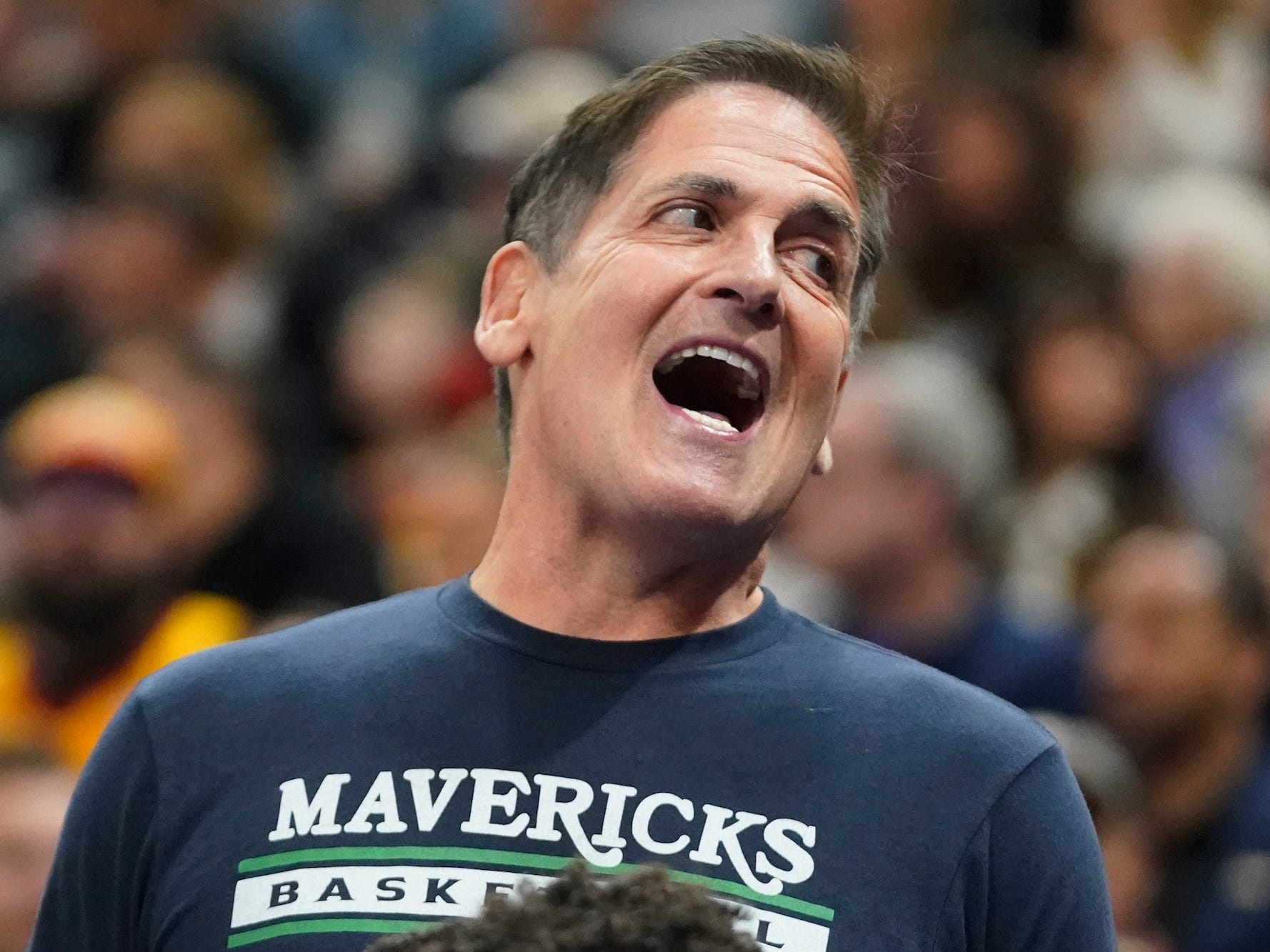 Mark Cuban smiles during an NBA game.