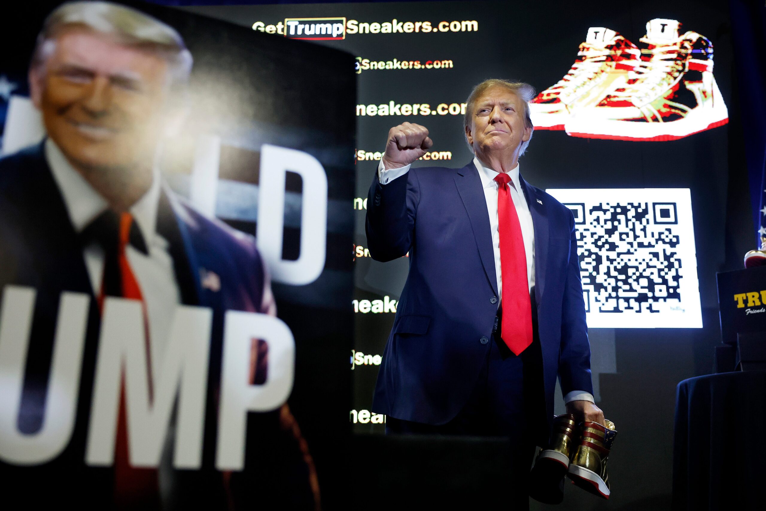 Trump holding Trump-brand shoes