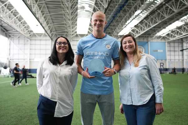 Erling Haaland with Georgiana Anitei (Left) at a Socios.com event