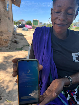 Jane Mago shows off the app. Blockchain environmental cleanup